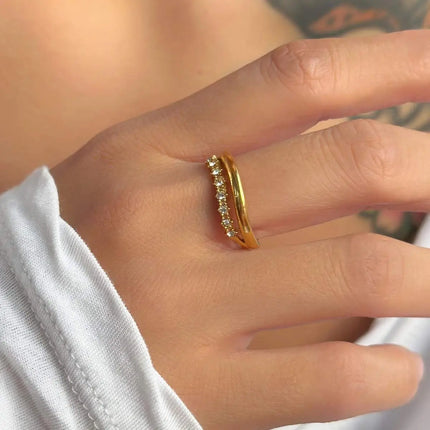 Gold ring with diamonds on a person's finger