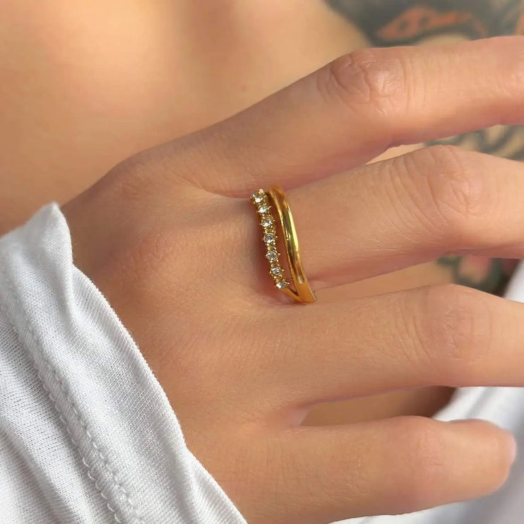 Gold ring with diamonds on a person's finger