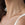 Close-up of a gold necklace on a person's neck