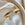 Gold stainless steel cuff bracelet with star-shaped engravings on a soft satin fabric background