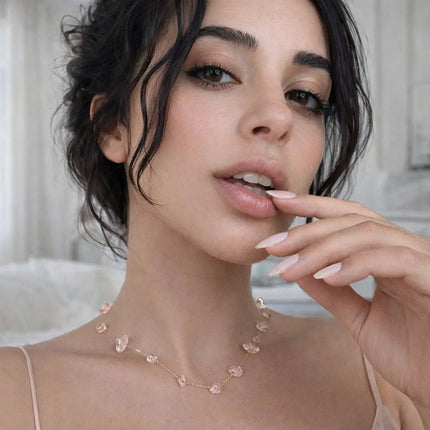 Woman wearing a delicate necklace with a blurred background