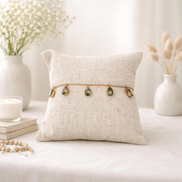 Jewelry displayed on a pillow with a neutral background
