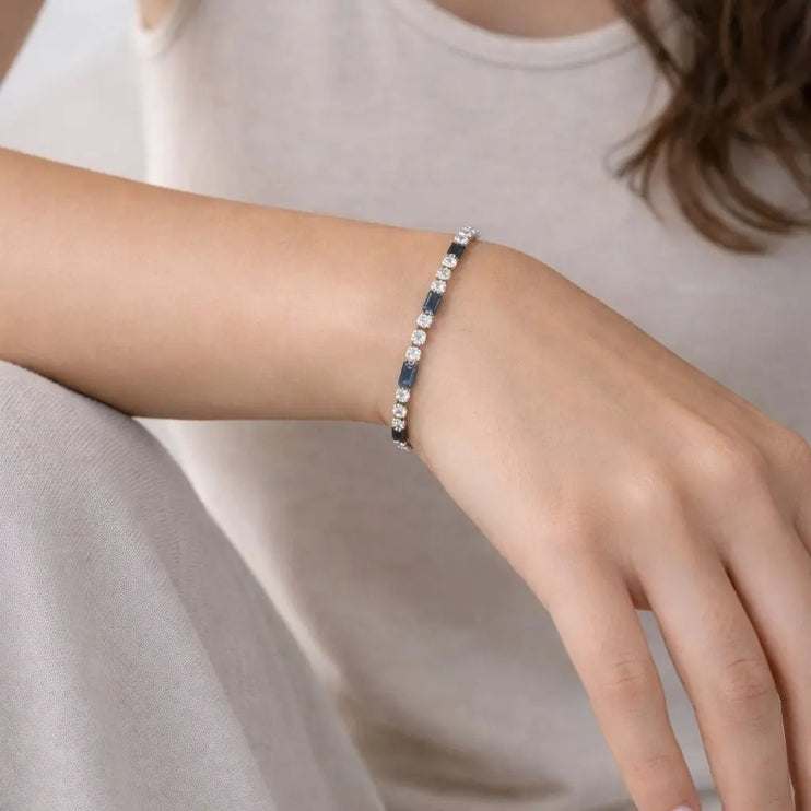Bracelet on a wrist with a neutral background