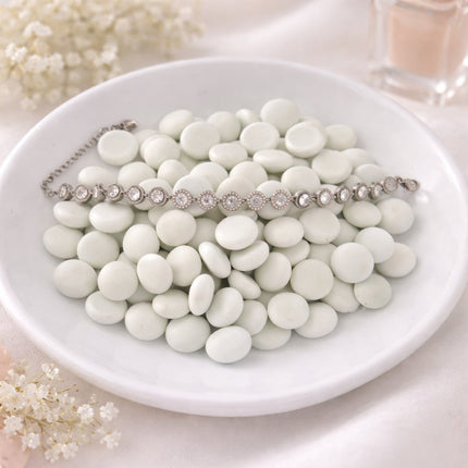 Necklace with white stones on a white plate