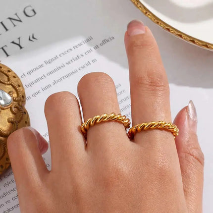 Gold ring on a finger with a decorative background