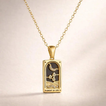 Gold pendant necklace with intricate design on a beige background