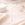 Gold necklace on a soft beige fabric background