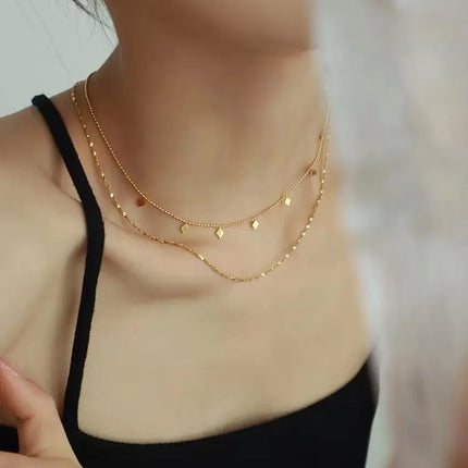 Gold necklace on a person with a blurred background