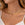 Minimalist gold stainless steel necklace worn by a woman, featuring layered chains with small bead accents