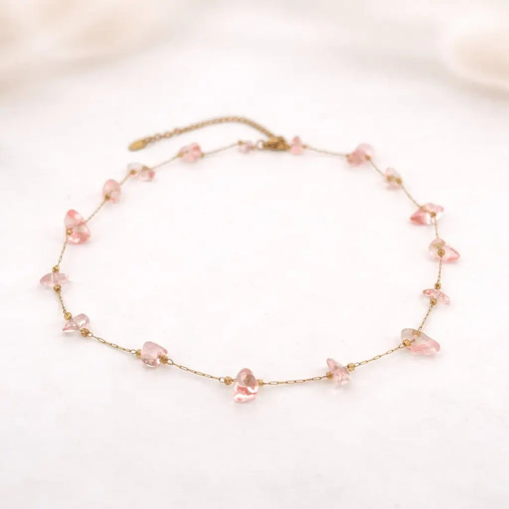Delicate necklace with pink beads on a light background