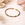 Multicolored gemstone bracelet on a light surface with a hand and small bowl in the background.