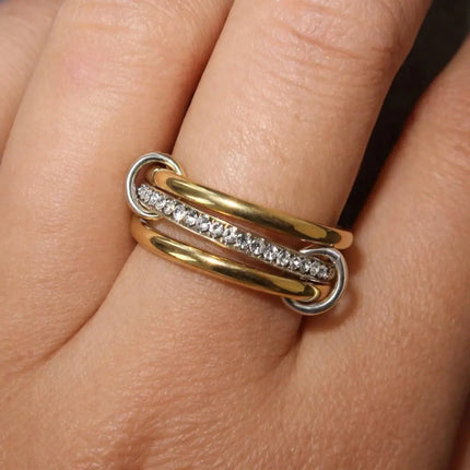 Gold and silver ring with diamonds on a finger
