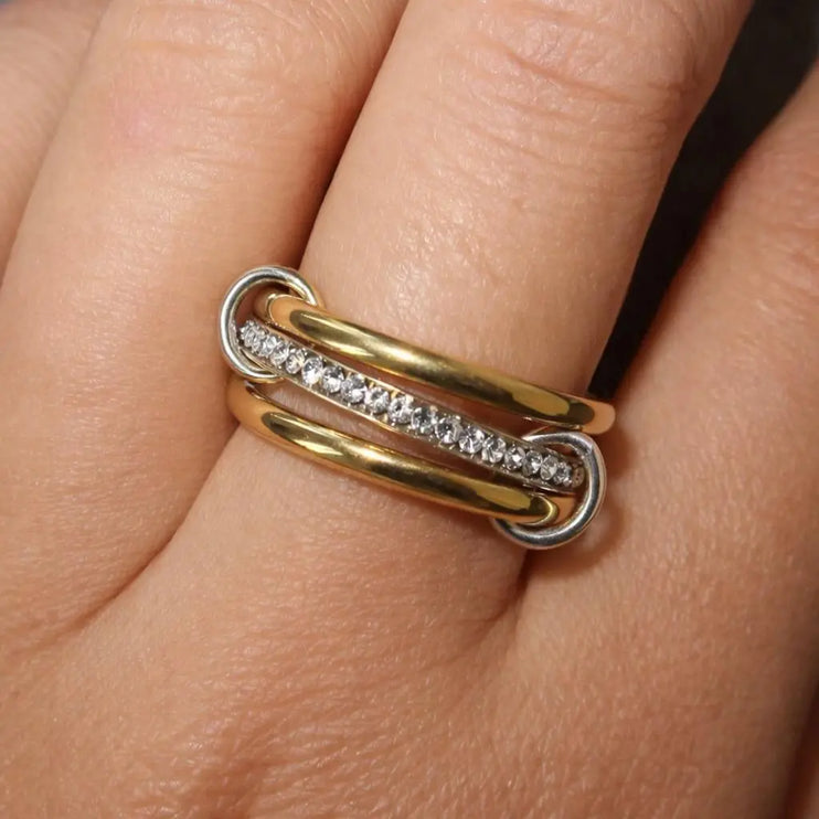 Gold and silver ring with diamonds on a finger