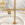 Gold hoop earrings on a gold stand with a marble background